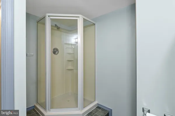 a bathroom with a glass shower door