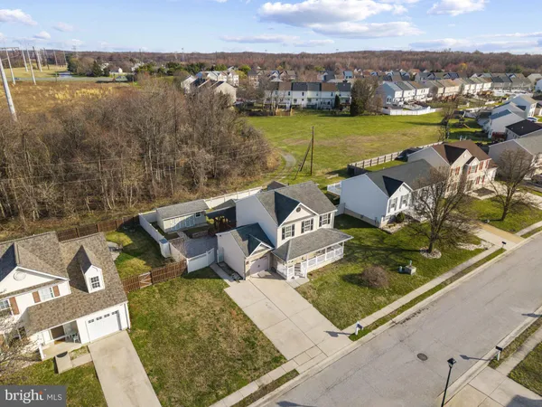 an aerial view of a house with a garden and lake view