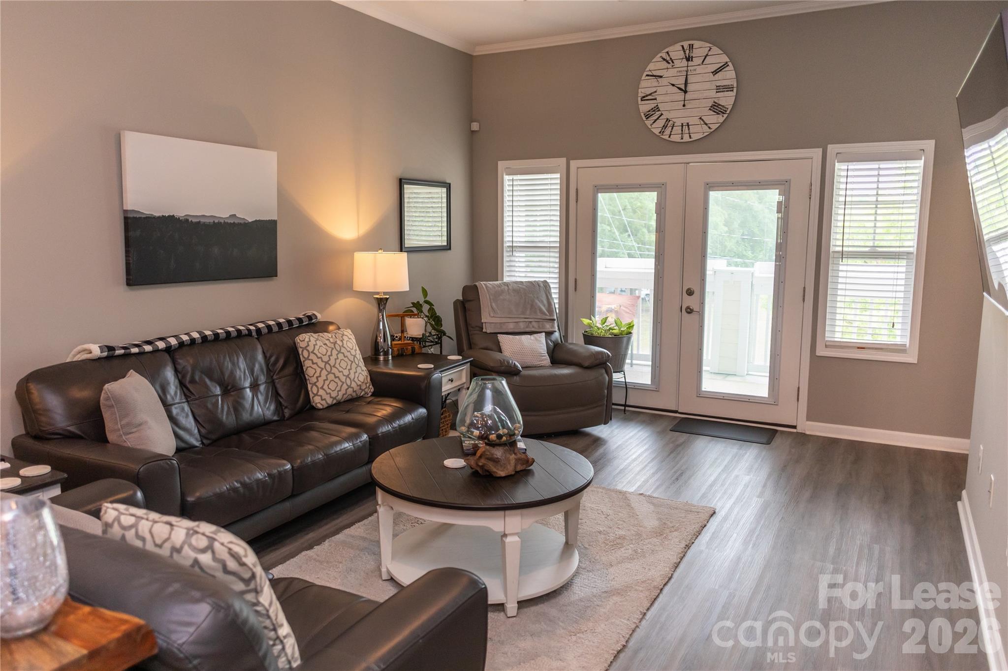 107 White Street, Unit B Morganton, NC 28655 - Photo 11 of 18 a living room with furniture a wooden floor and a large window
