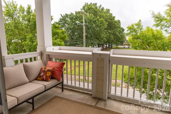 a balcony with furniture and garden view
