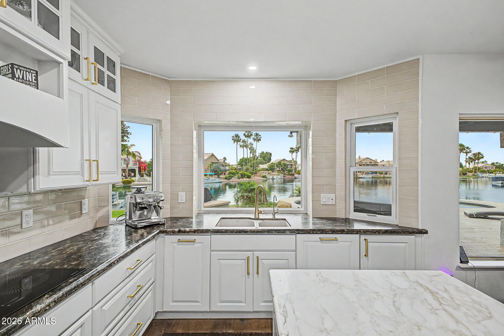 1434 West Key Harbor Drive Gilbert, AZ 85233 - Photo 123 of 144 a large kitchen with kitchen island a large window sink and cabinets