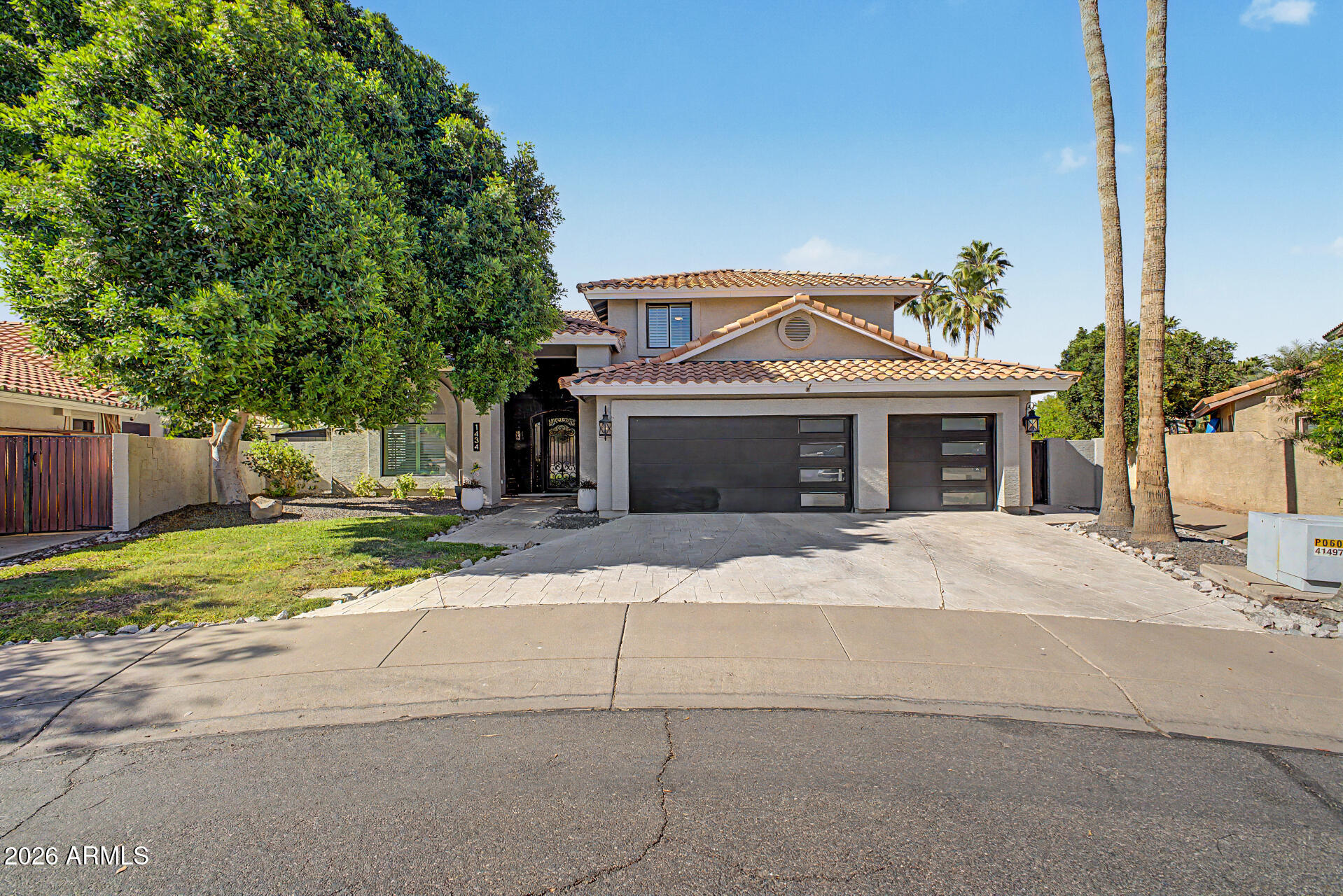 1434 West Key Harbor Drive Gilbert, AZ 85233 - Photo 3 of 144 a front view of a house with a yard and a garage