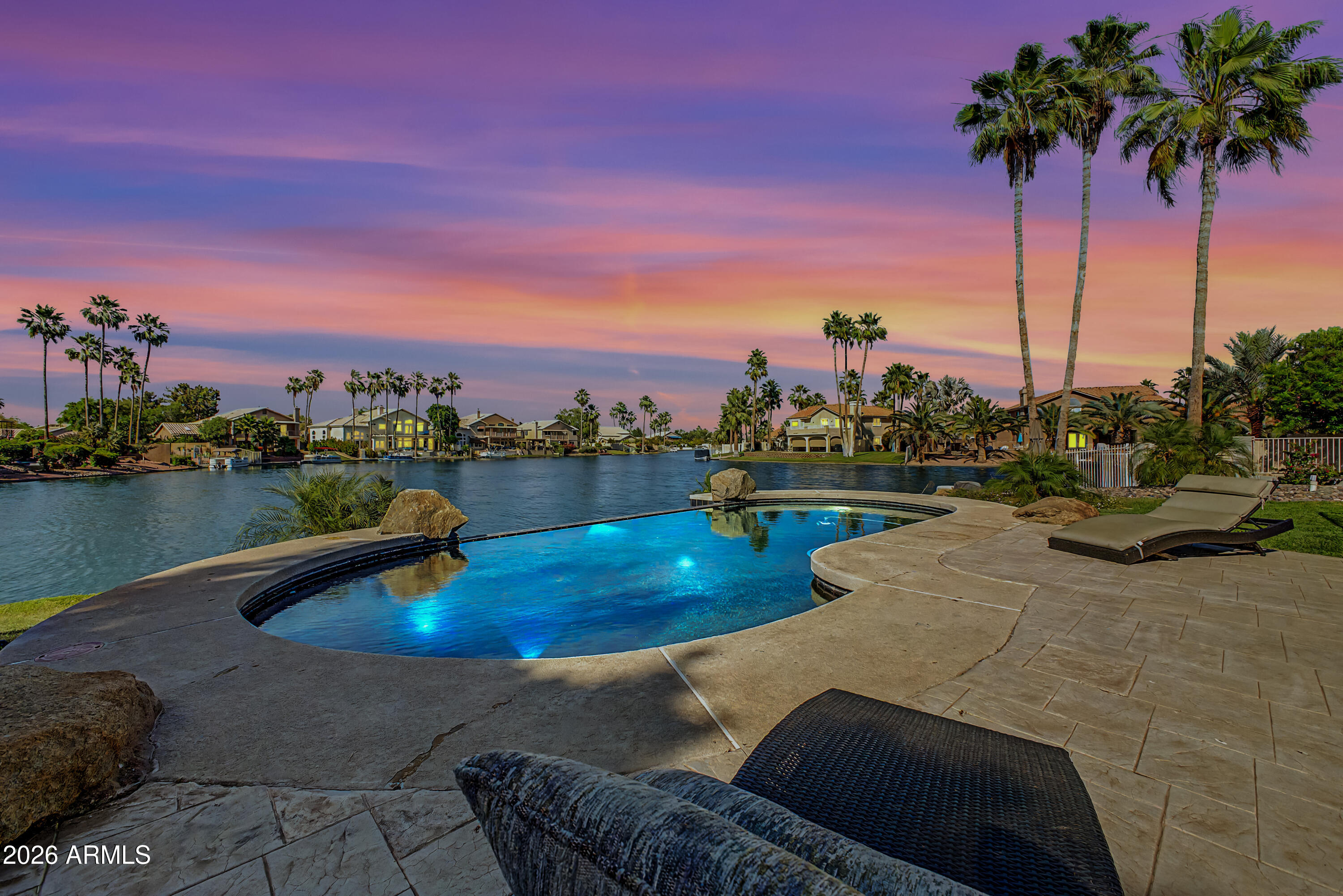 1434 West Key Harbor Drive Gilbert, AZ 85233 - Photo 40 of 144 a view of a swimming pool with a lake view and a trees in the background