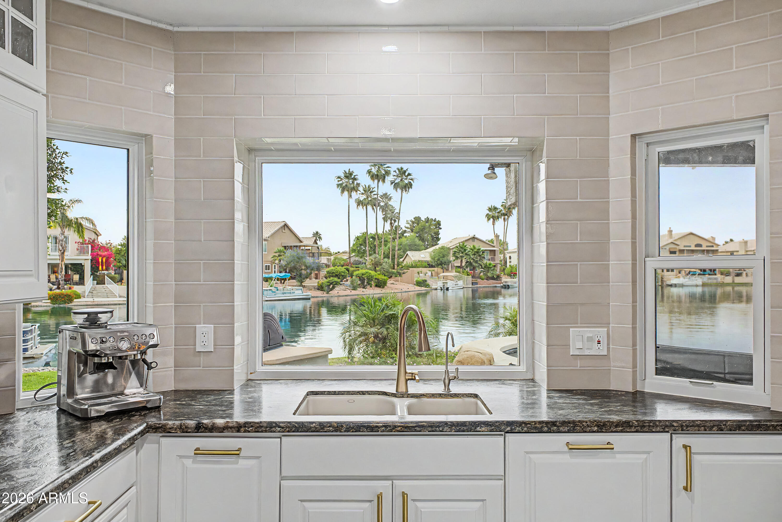 1434 West Key Harbor Drive Gilbert, AZ 85233 - Photo 57 of 144 a kitchen with granite countertop a window and a white counter top space