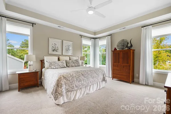 a spacious bedroom with a bed and a window