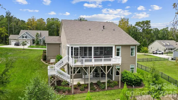 a view of house with backyard and outdoor seating
