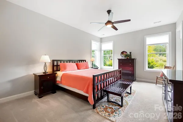 a bedroom with a bed and a large window