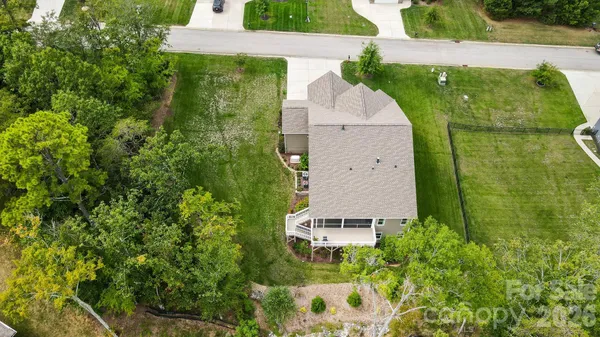 an aerial view of a house with a yard