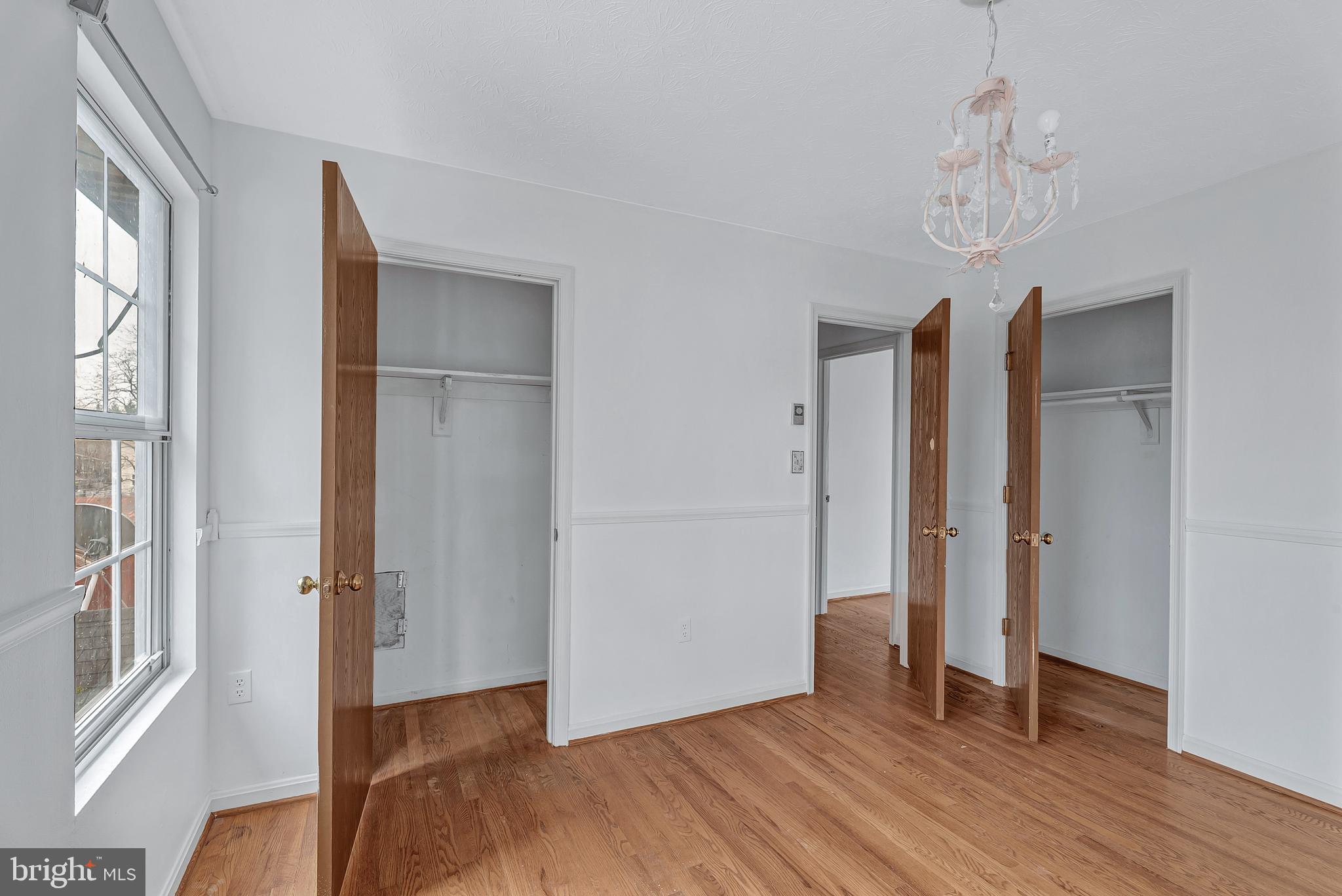 210 Brunswick Road Stephens City, VA 22655 - Photo 11 of 18 an empty room with wooden floor and windows