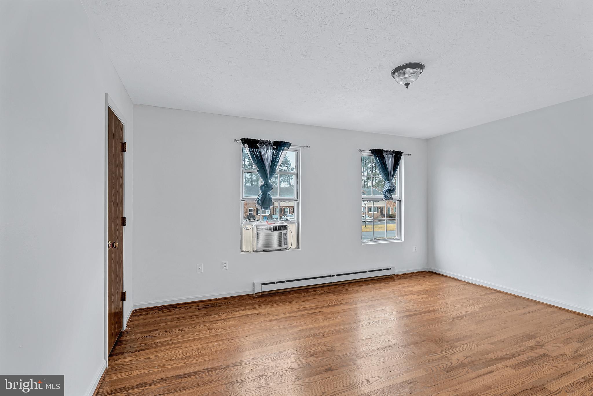 210 Brunswick Road Stephens City, VA 22655 - Photo 12 of 18 an empty room with wooden floor and window
