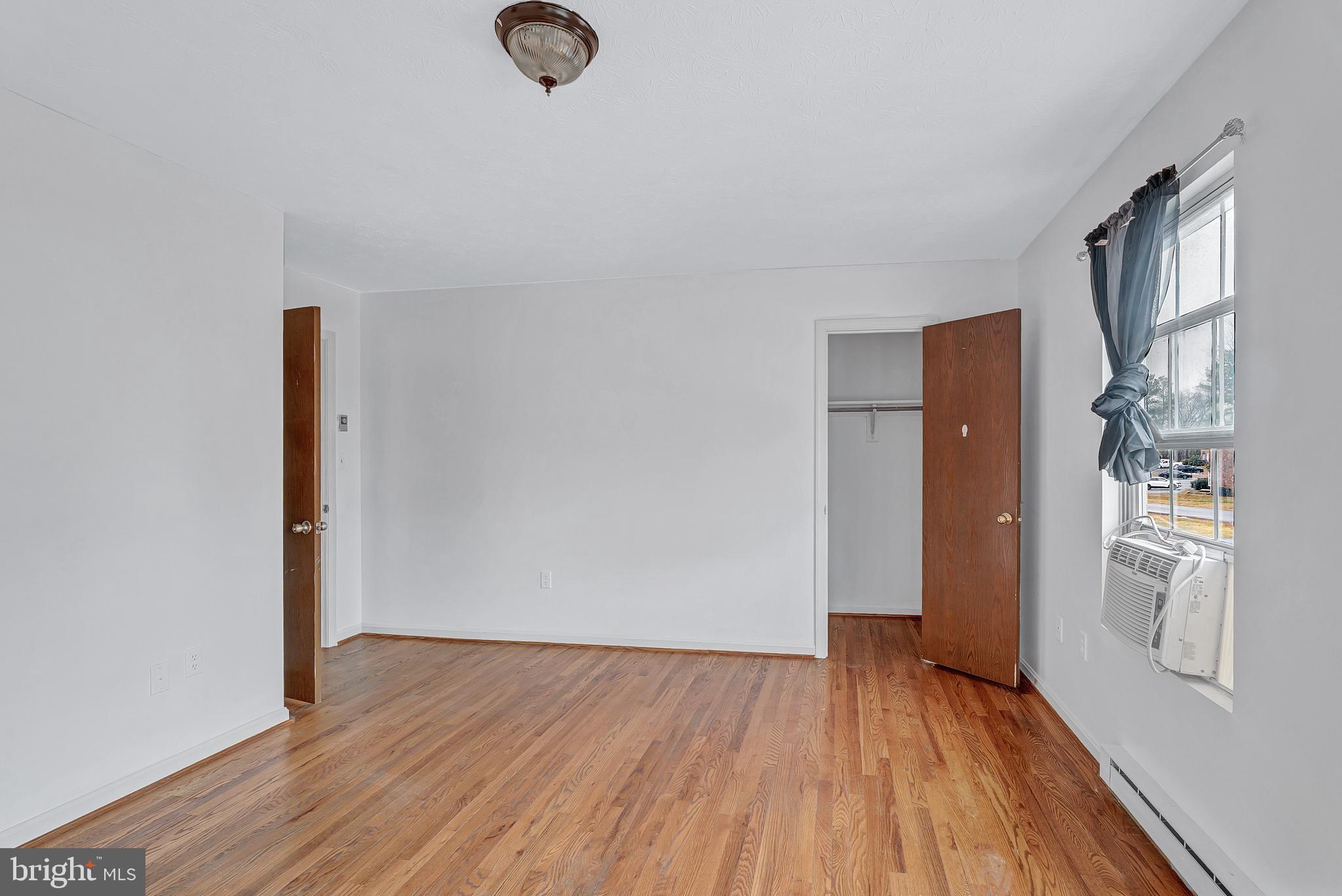 210 Brunswick Road Stephens City, VA 22655 - Photo 15 of 18 an empty room with wooden floor and windows