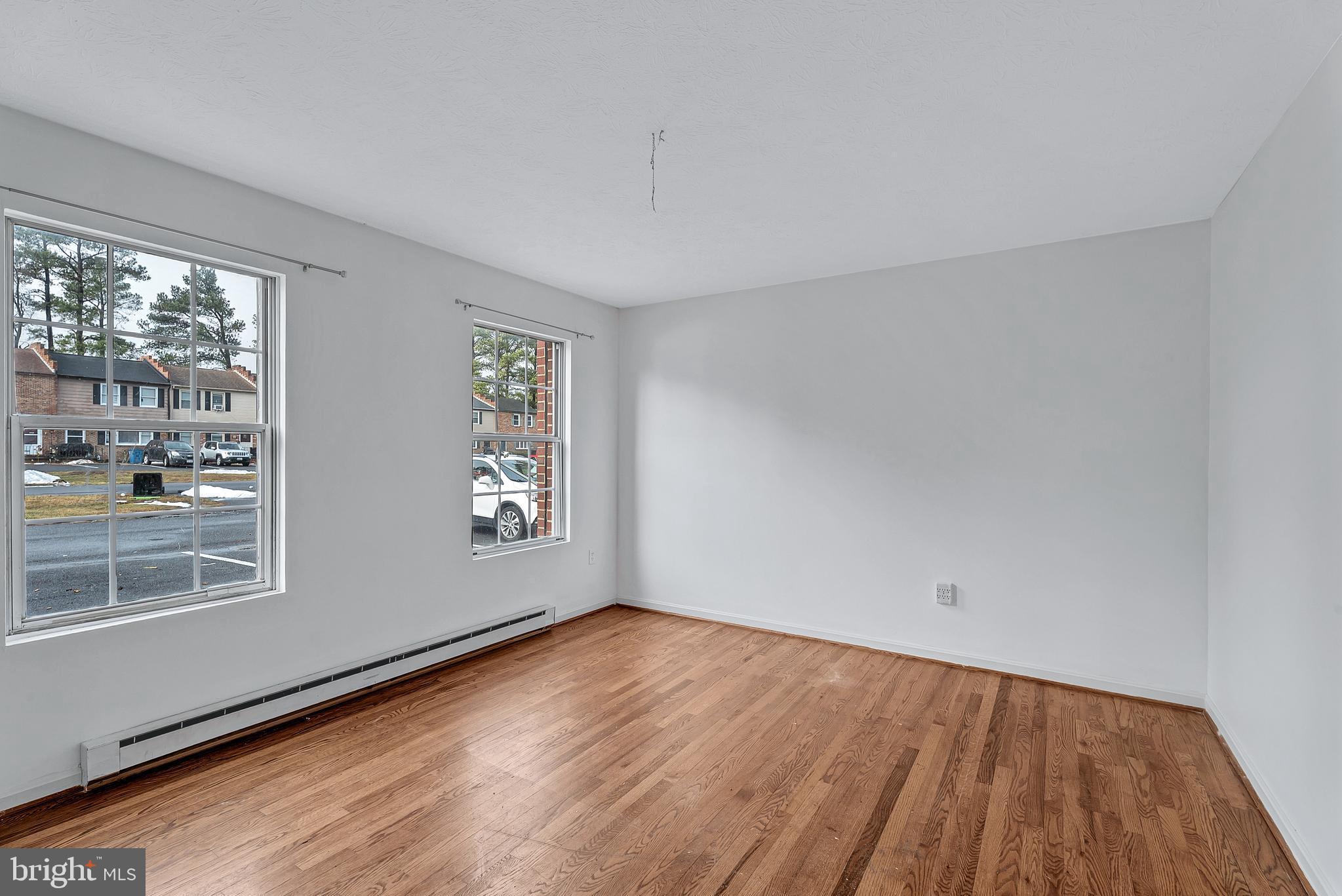 210 Brunswick Road Stephens City, VA 22655 - Photo 2 of 18 a view of an empty room with wooden floor and a window