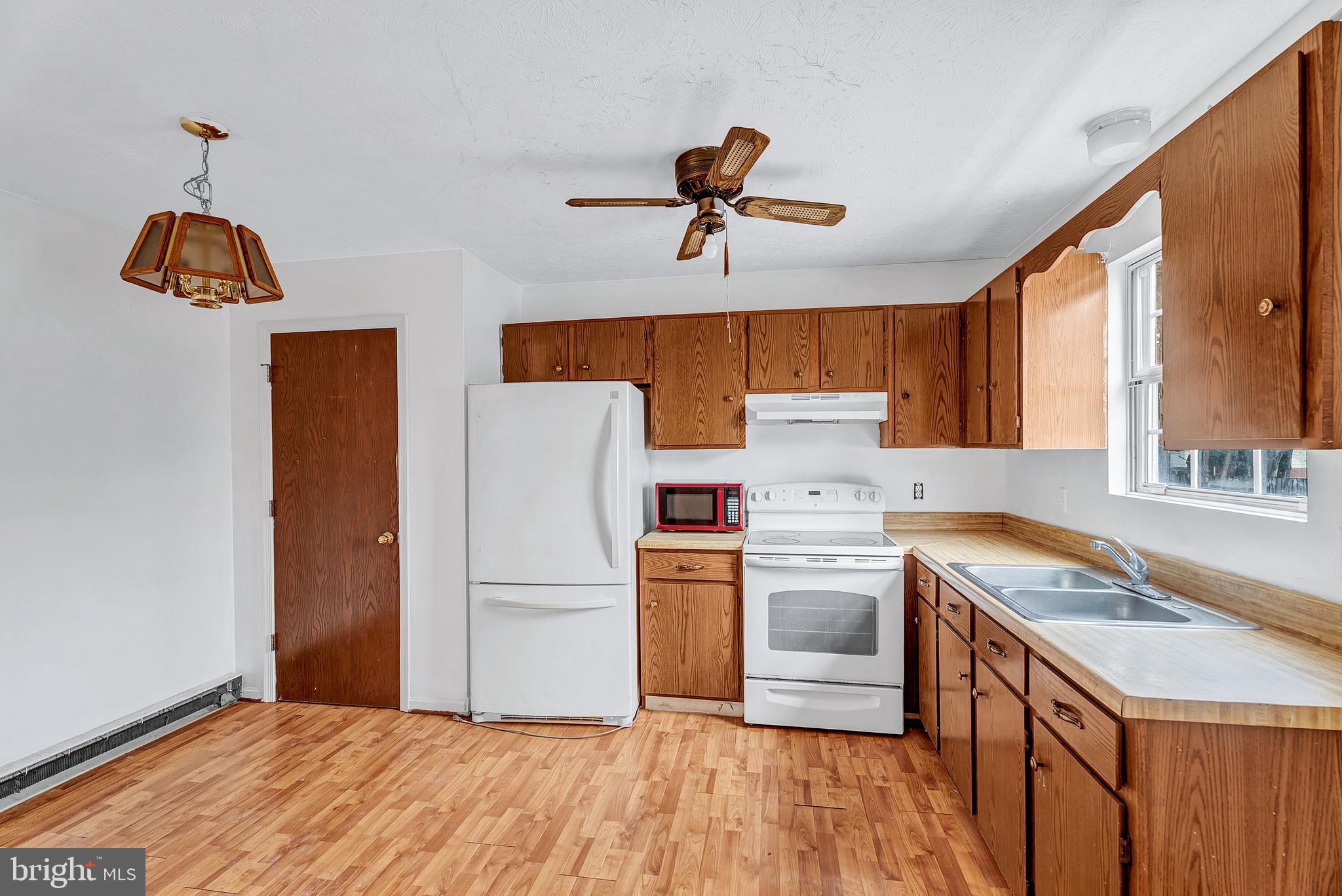 210 Brunswick Road Stephens City, VA 22655 - Photo 5 of 18 a kitchen with a stove a sink and a refrigerator