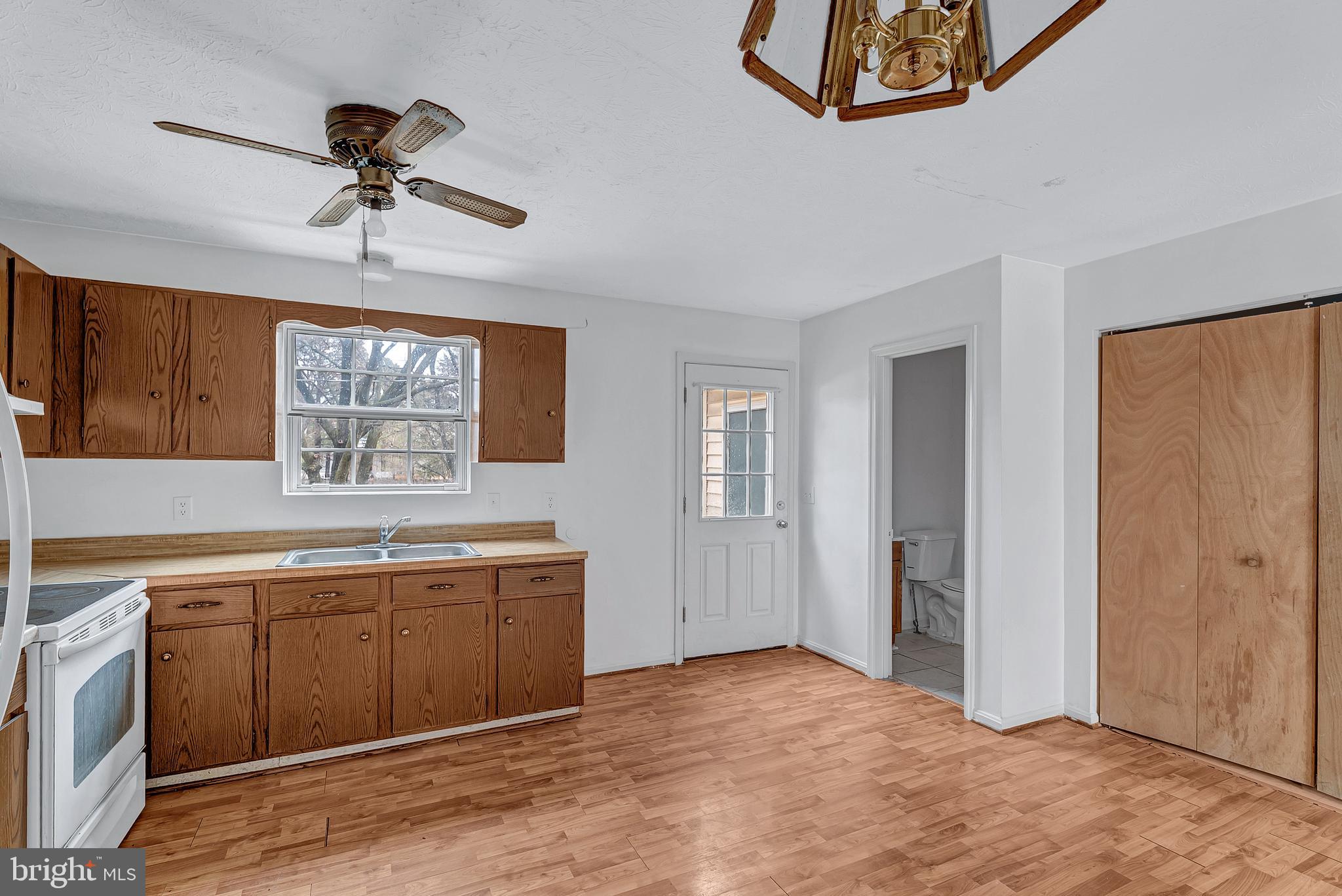 210 Brunswick Road Stephens City, VA 22655 - Photo 6 of 18 a view of a kitchen with a sink and wooden cabinet