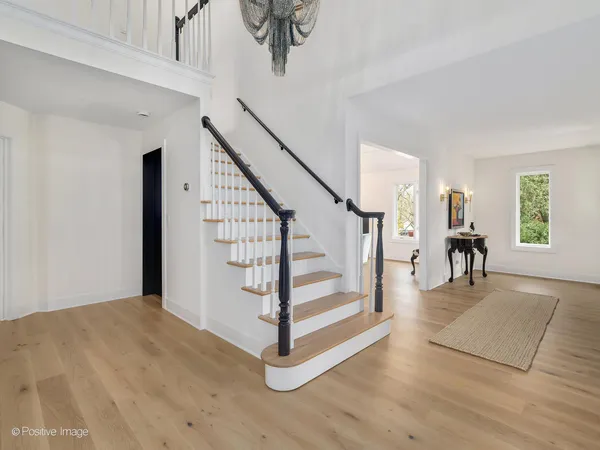 a view of entryway and hall with wooden floor