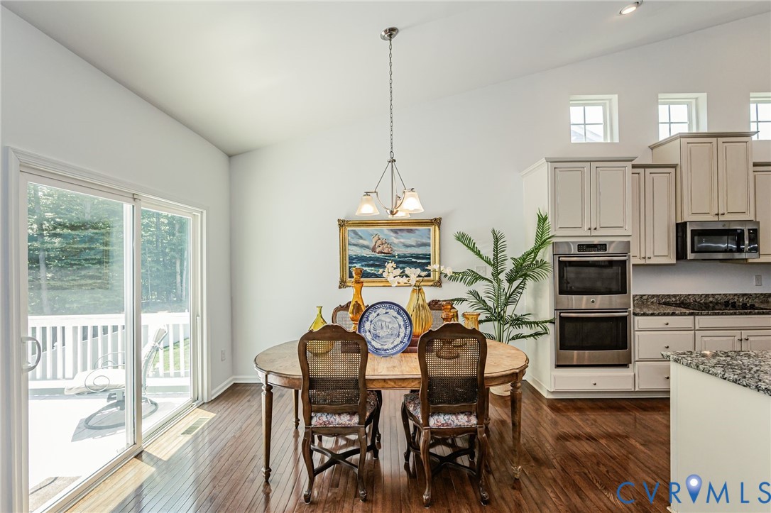 7435 Wicks Road Williamsburg, VA 23188 - Photo 22 of 82 Open-concept dining area featuring wood-finish flo