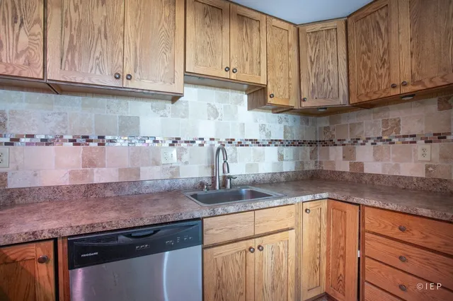 a kitchen with granite countertop cabinets stainless steel appliances and a counter space