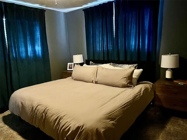 a bedroom with a bed and lamp