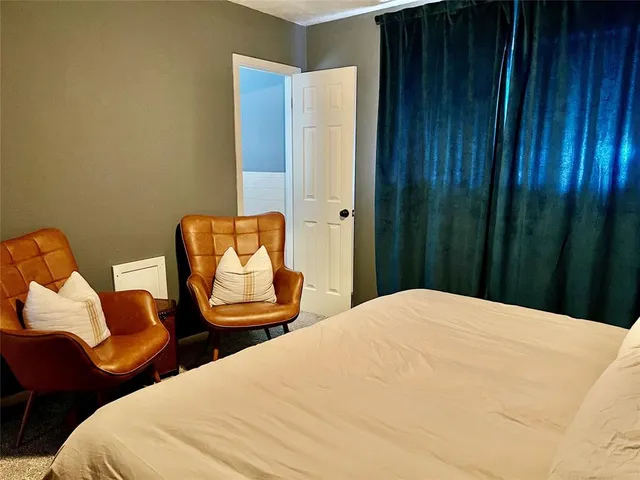 a bedroom with bed and chair
