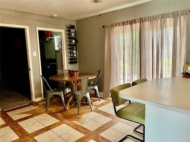 a dining room with furniture and window