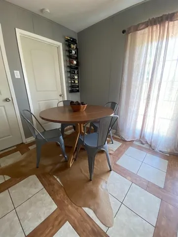 a view of a room with furniture and window