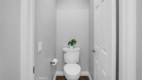 a white toilet sitting in a bathroom next to a sink