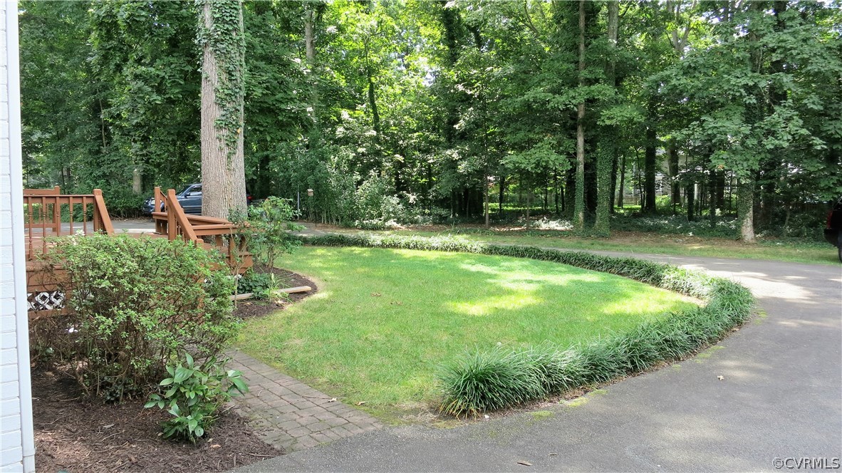 2420 Wadebridge Road Midlothian, VA 23113 - Photo 14 of 50 a view of backyard with a table and chairs