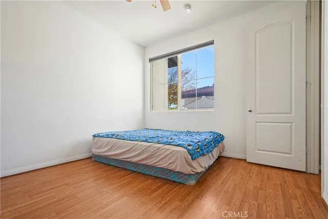 a bedroom with a bed and a painting on the wall