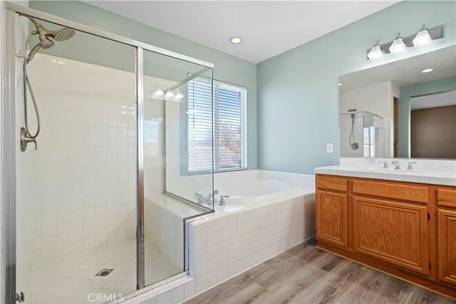 a bathroom with a tub sink shower and mirror