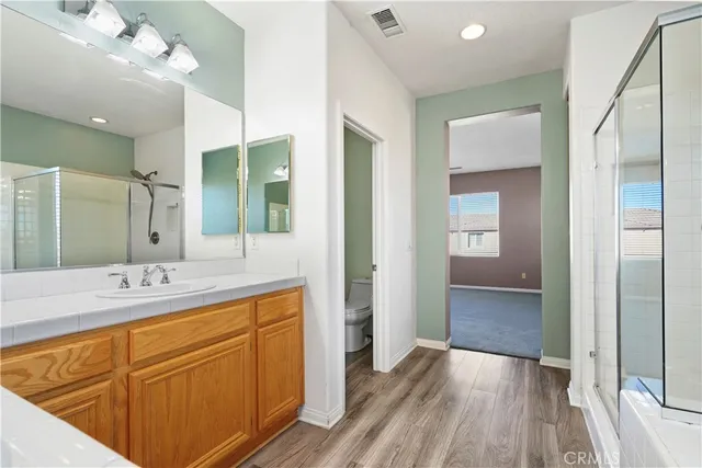 a bathroom with a sink a mirror and a shower