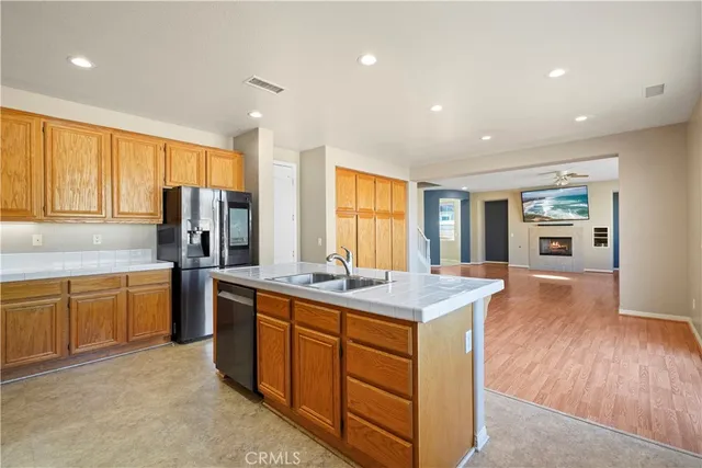 a kitchen with sink stove and refrigerator