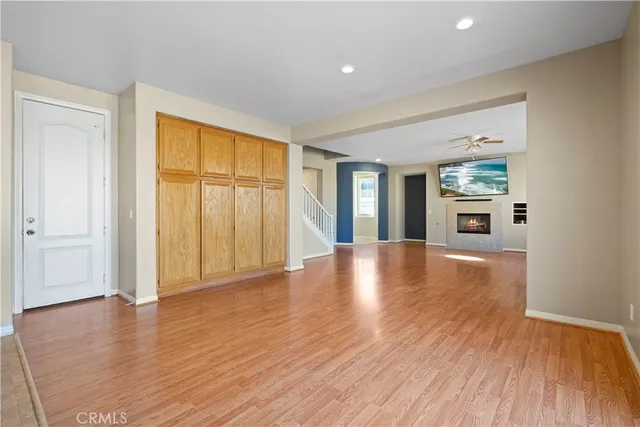 a view of a livingroom with furniture wooden floor and windows