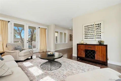 a living room with furniture a fireplace and a table