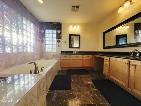 a kitchen with granite countertop a stove a sink and a microwave
