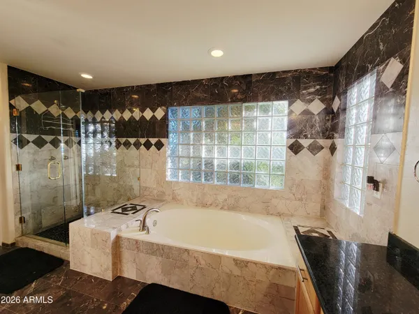 a bathroom with a bathtub and a shower