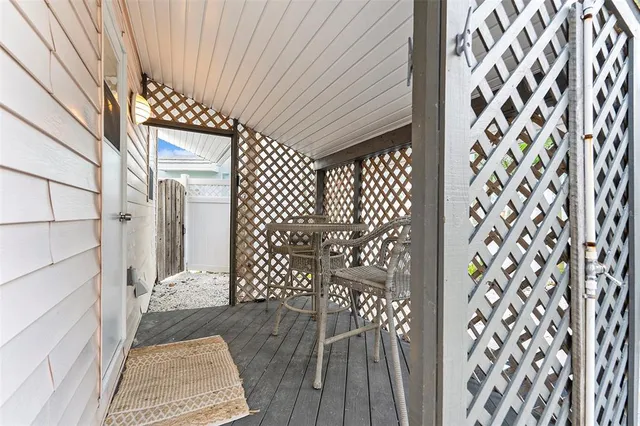 a bedroom with a bed a window and a flat screen tv