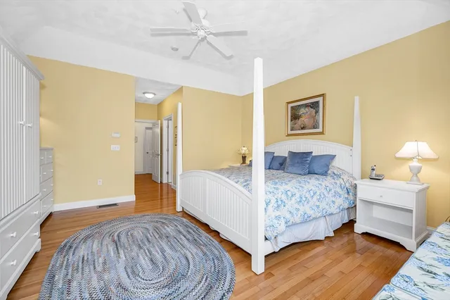 a spacious bedroom with a bed and a chandelier