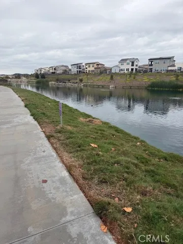 a view of a lake with houses in the back