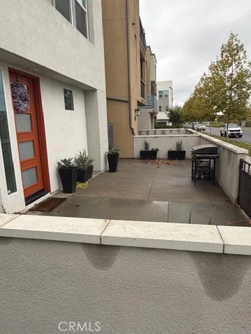 a view of a street with potted plants