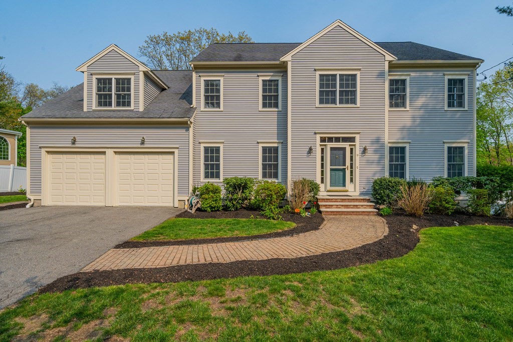 9 Bates Road Lexington, MA 02421 - Photo 1 of 42 a front view of a house with a yard and garage