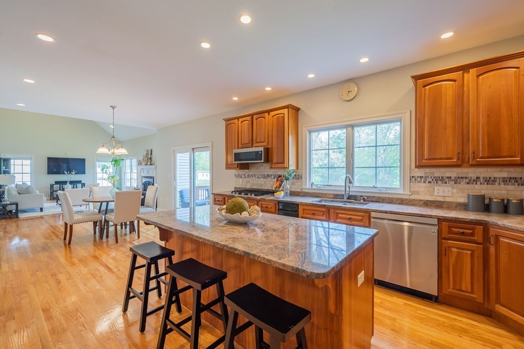 9 Bates Road Lexington, MA 02421 - Photo 11 of 42 a kitchen with a dining table chairs sink and cabinets