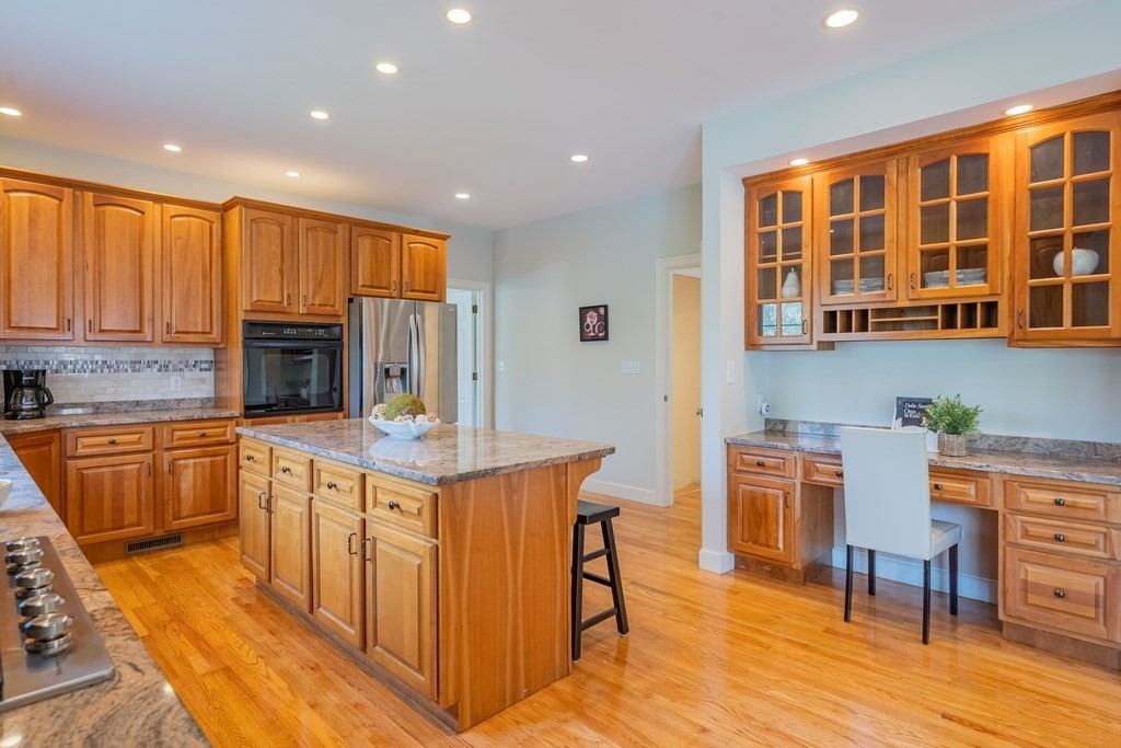 9 Bates Road Lexington, MA 02421 - Photo 14 of 42 a kitchen with stainless steel appliances granite countertop a stove top oven a sink dishwasher and cabinets with wooden floor