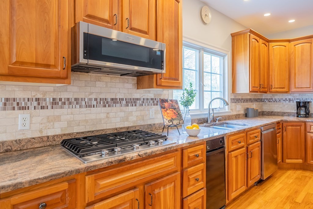 9 Bates Road Lexington, MA 02421 - Photo 15 of 42 a kitchen with stainless steel appliances granite countertop a stove a sink and a microwave