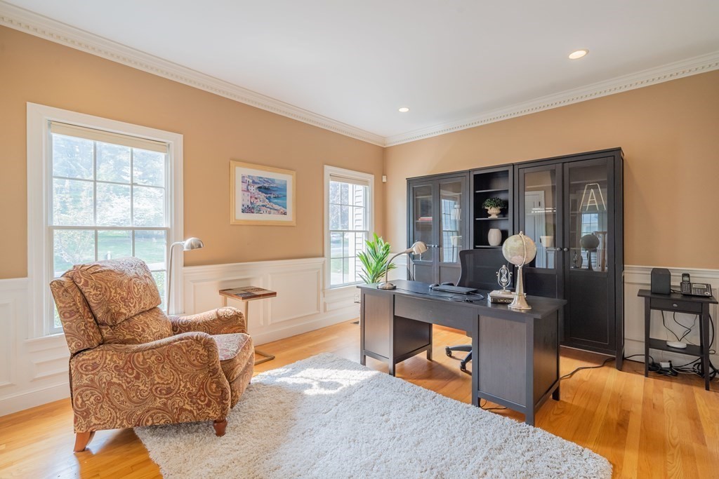 9 Bates Road Lexington, MA 02421 - Photo 25 of 42 a living room with furniture a dining table and a flat screen tv