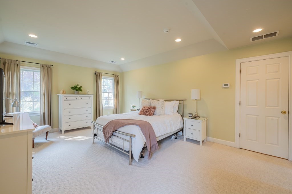 9 Bates Road Lexington, MA 02421 - Photo 29 of 42 a spacious bedroom with a bed and a couch