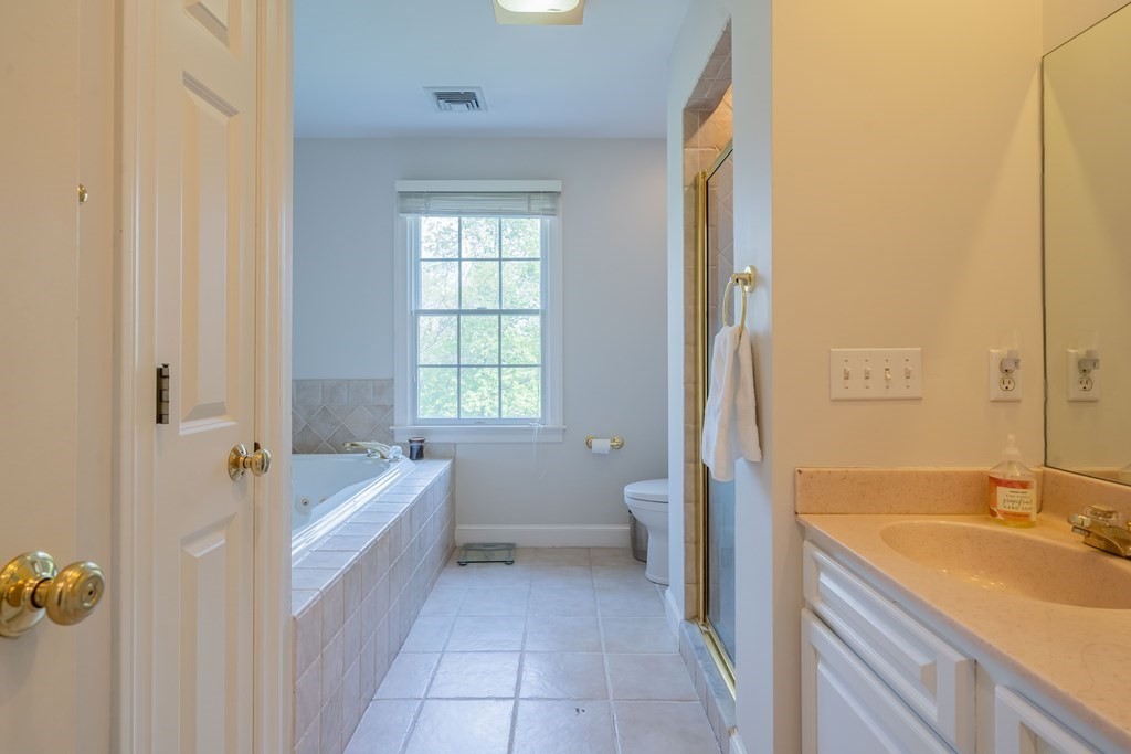9 Bates Road Lexington, MA 02421 - Photo 31 of 42 a bathroom with a sink a bathtub and a toilet