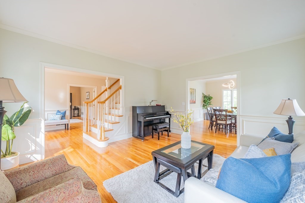 9 Bates Road Lexington, MA 02421 - Photo 4 of 42 a living room with furniture a dining table and a fireplace