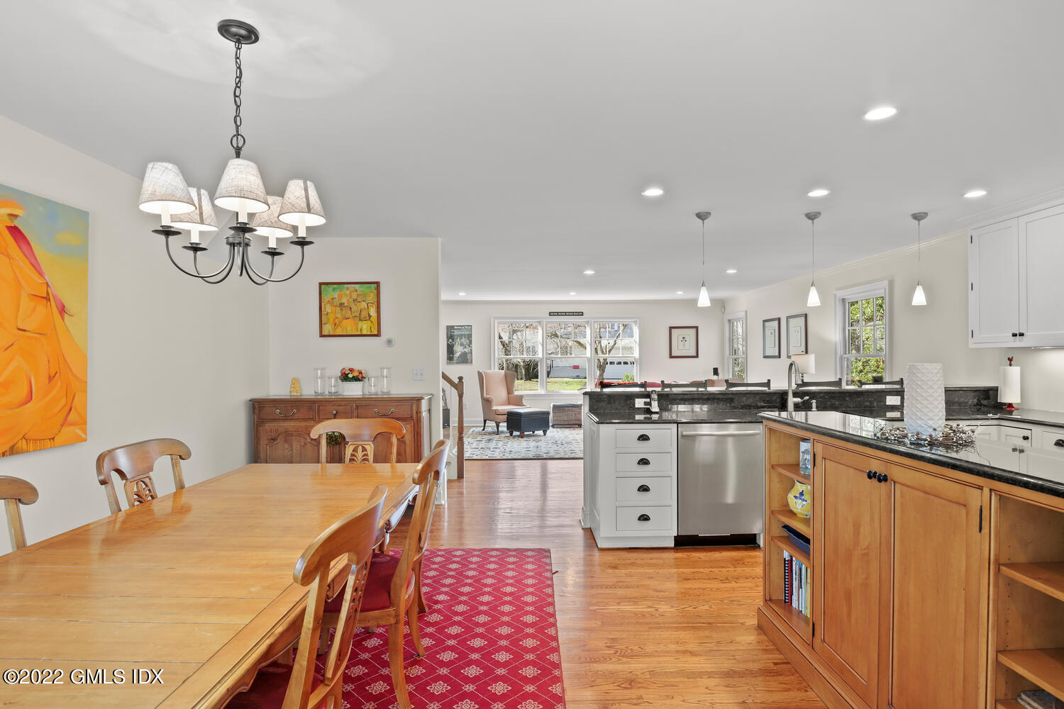 4 Rainbow Drive Riverside, CT 06878 - Photo 11 of 59 a kitchen with stainless steel appliances granite countertop a sink dishwasher stove refrigerator and couches with wooden floor