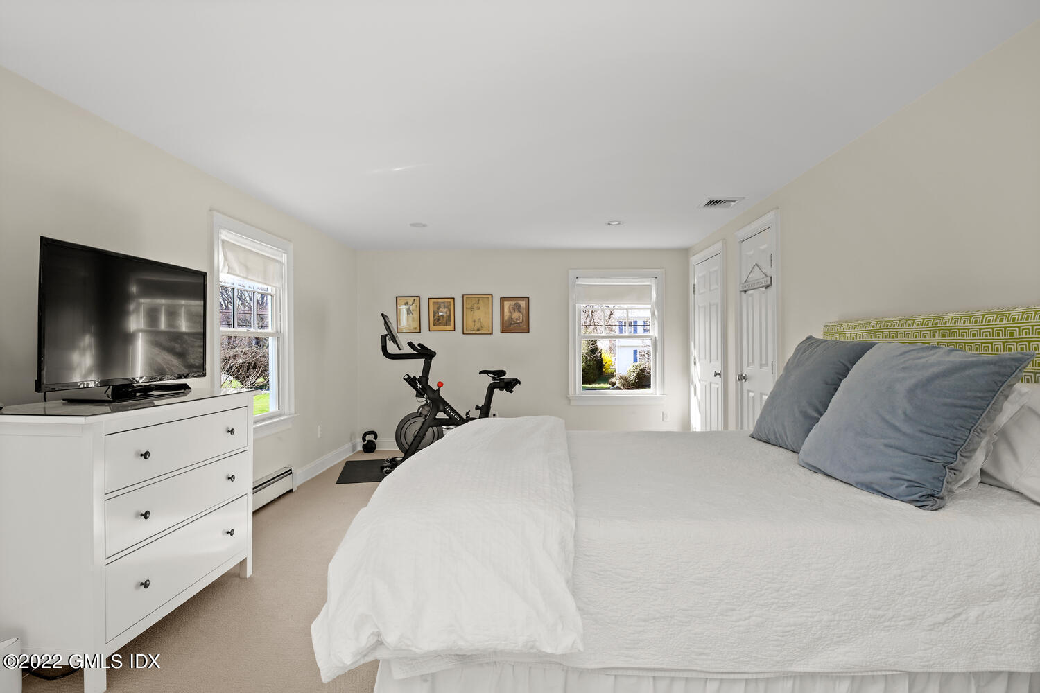 4 Rainbow Drive Riverside, CT 06878 - Photo 24 of 59 a bedroom with a large bed and a flat screen tv on dresser