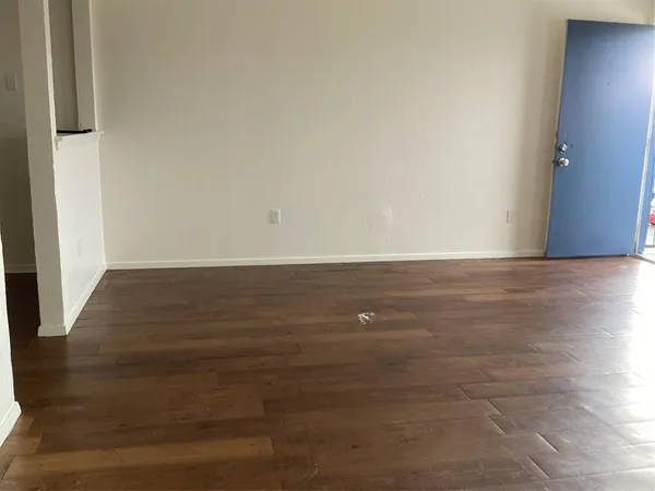 a view of room with wooden floor